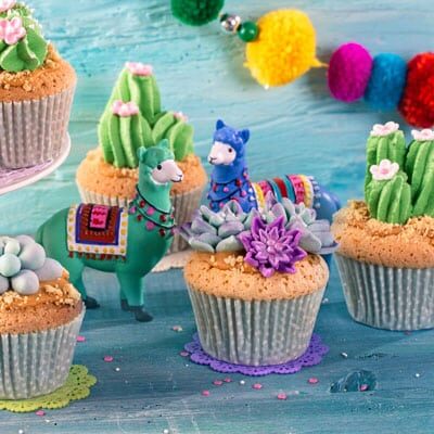 Frosted cupcakes and toy llamas